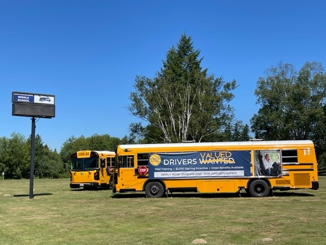 Snoqualmie Valley School District bus with hiring sign on side of bus.